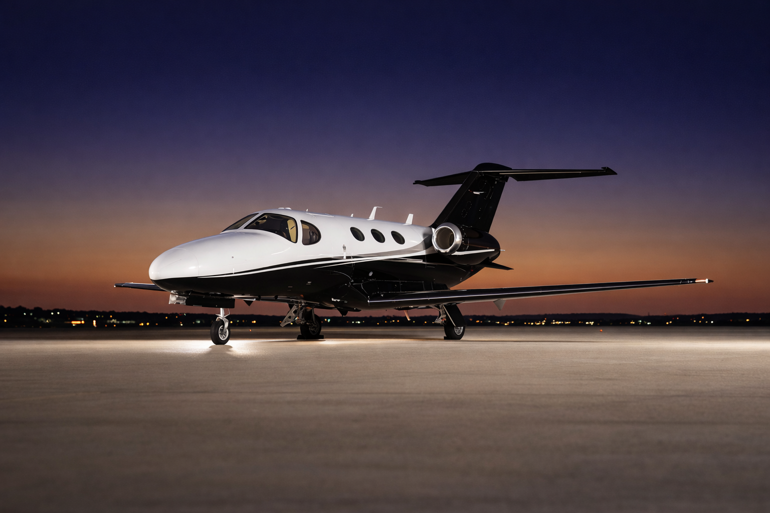 Cessna Citation Mustang on tarmac at night
