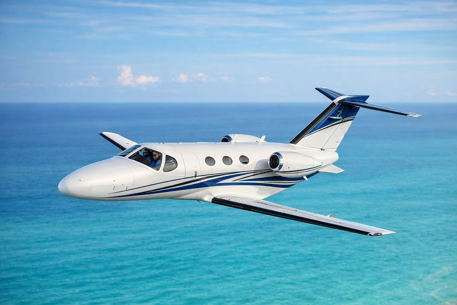 Cessna Citation Mustang flying over ocean