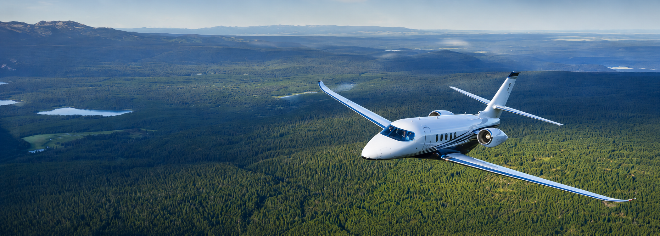 Cessna Citation Latitude in flight over forest