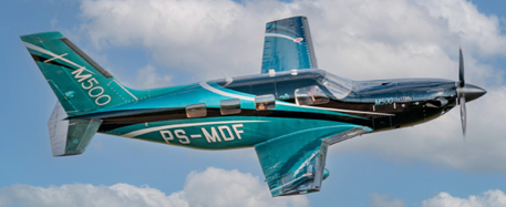 Piper M500 close-up side view in-flight with blue skies