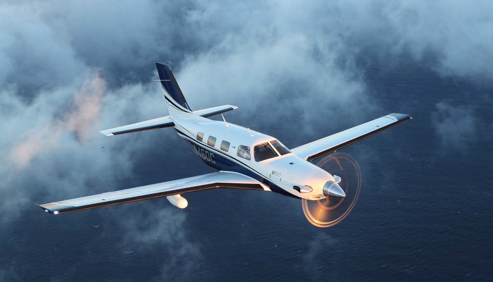 Piper M500 in flight over ocean