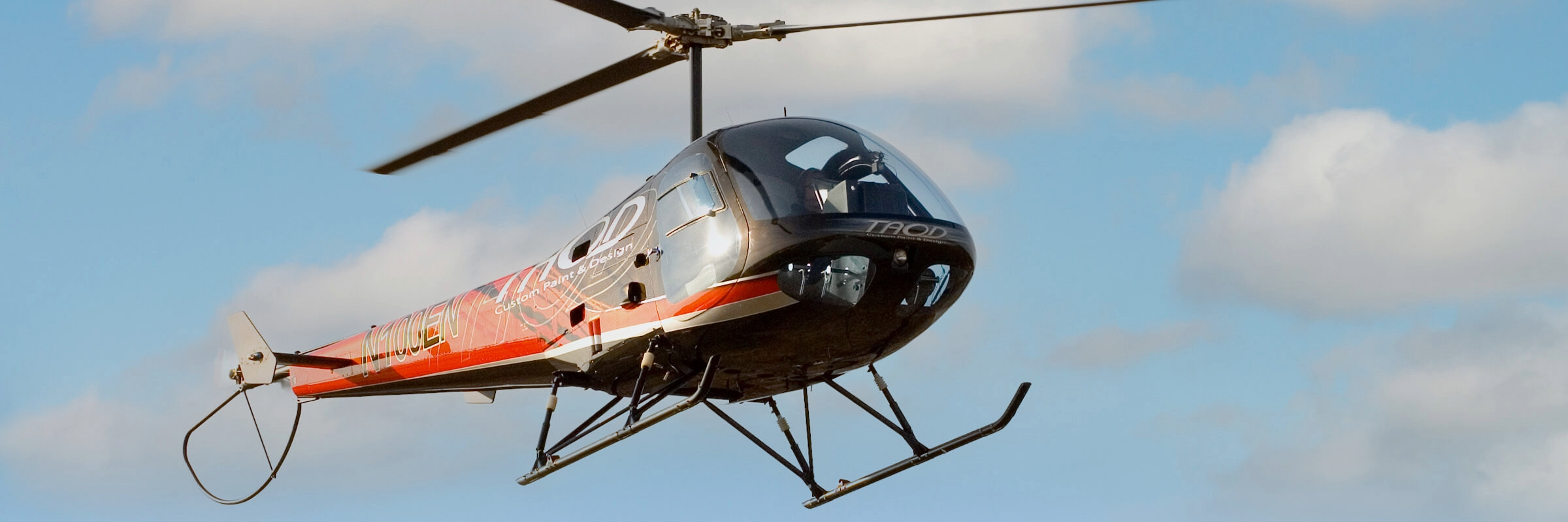 Enstrom F28F piston helicopter against a blue sky